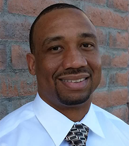 Black male with brown hair and brown eyes.