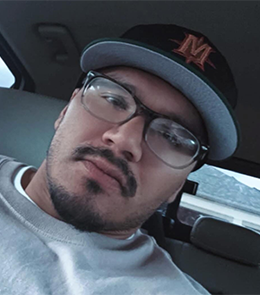 Hispanic or Latino person with brown hair and brown eyes.