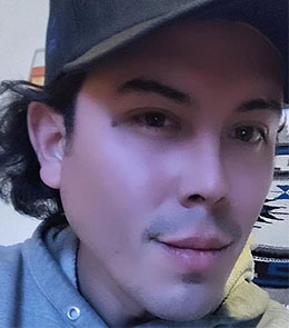 Hispanic male with hazel eyes and brown hair.