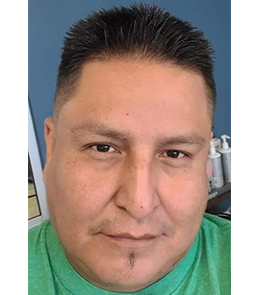 American Indian male with brown eyes and black hair.