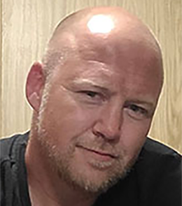 White male blue eyes with bald head.