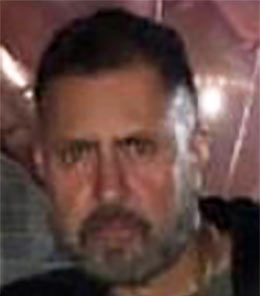 Hispanic male with hazel eyes and brown hair.