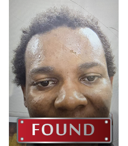 Black male with black hair and brown eyes.