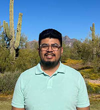 a man wearing glasses and polo shirt