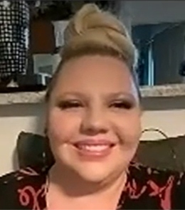 Person with blonde hair smiling