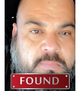 Hispanic male with brown eyes and bald head.