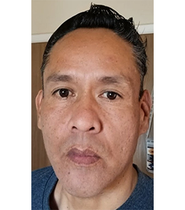 American Indian or Alaska Native with brown hair and brown eyes.