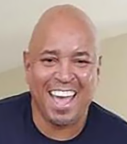 Black male with brown eyes and black hair.