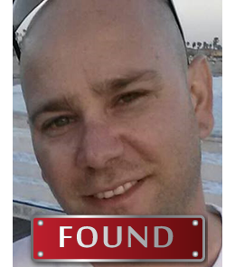 White male with bald head and brown eyes.