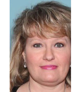 Close-up of a woman's face with blond hair and pink lipstick against a blue background.