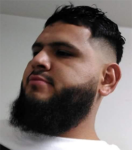 Hispanic or Latino person with black hair and brown eyes.