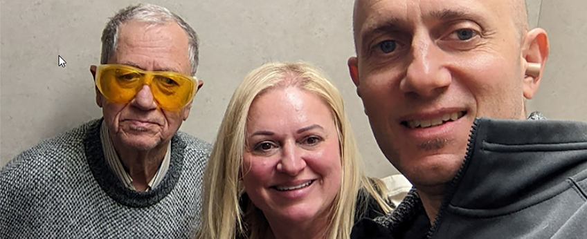 two men and a woman are smiling
