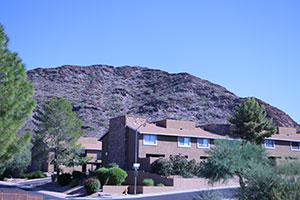 apartment complex in front of a mountain