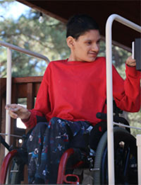 a young man in a wheelchair operating a chairlift