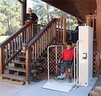 a young man in a wheelchair operating a chairlift