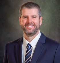 Director Wisehart wearing business suit