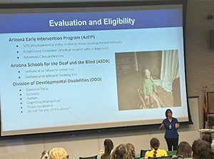 woman presenting a slide that reads "Evaluation and Eligibility