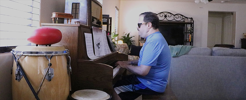 a man is playing the piano at home