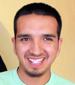 a Hispanic male with brown eyes, black hair, pierced ears, a mustache, and beard