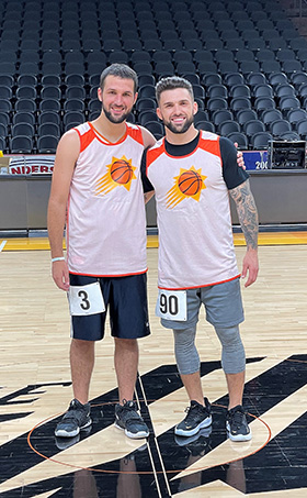 two young men wearing white jerseys with Phoenix Suns logo
