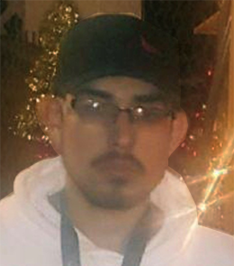 A Hispanic male with brown eyes, black hair, mustache and beard, wearing eye glasses.