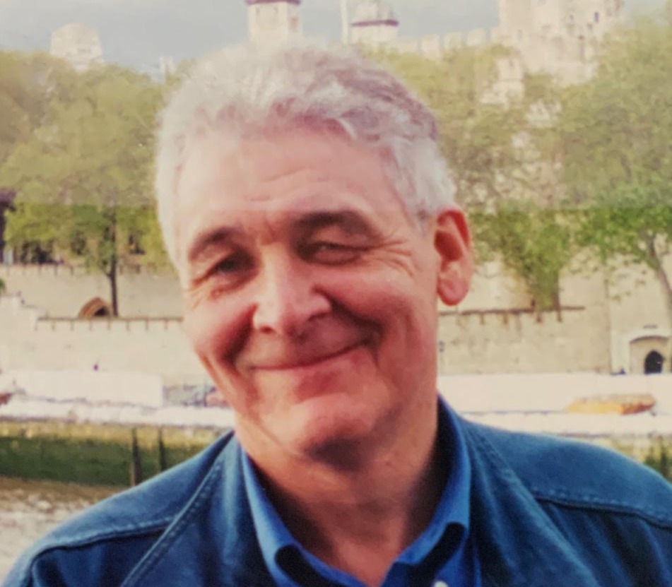 A White male with blues eyes and gray hair.