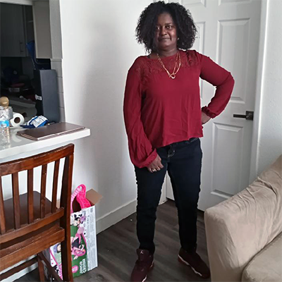 a woman is standing in her living room