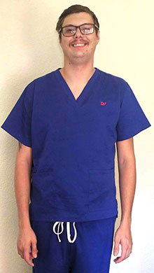 a man wearing blue scrubs