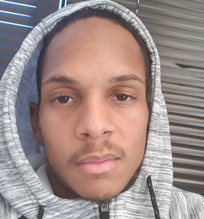 a young Black man wearing a hoodie