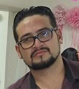 A Hispanic male with brown eyes, black hair, mustache and beard, wearing eye glasses.