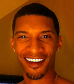 a Black male with brown eyes, black hair, mustache, and goatee