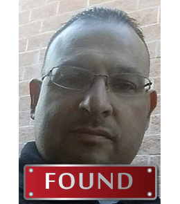 A Hispanic male with brown eyes, black hair, and glasses