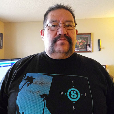 a man wearing glasses and a black t-shirt