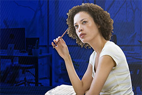 Woman sitting at desk, deep in thought