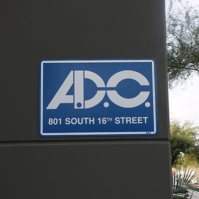 a sign on a building reads ADC 801 South 16th Street