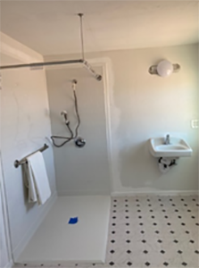 A newly installed barrier-free shower, bathroom sink and fixtures