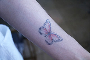 a butterfly tattoo on a person's arm