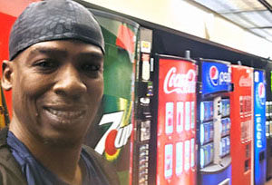 a young man standing near vending machines