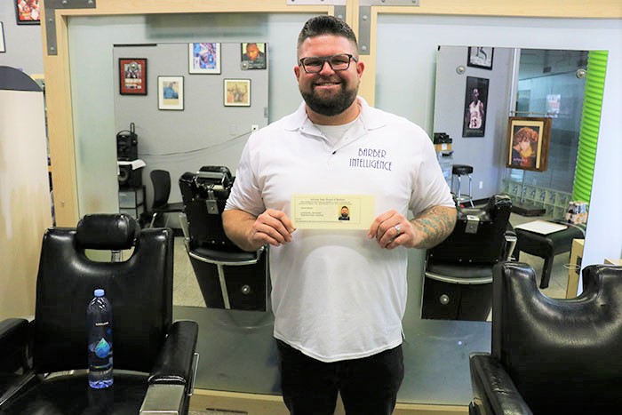 a man holding a certificate