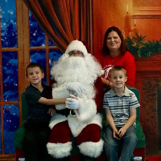 a family poses for a photo with Santa Claus