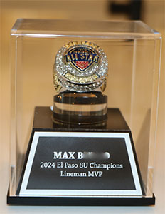 Close-up of Lineman Most Valuable Player ring in a display case.