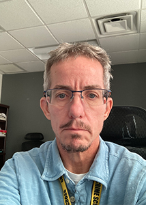 Person wearing glasses in an office.
