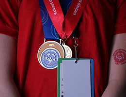 a teenage girl wearing two medals