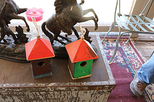Two colorful, homemade wooden birdhouses.