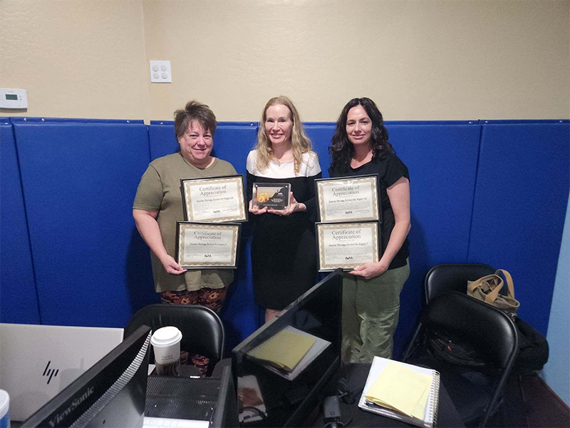 A group of women holding certificates