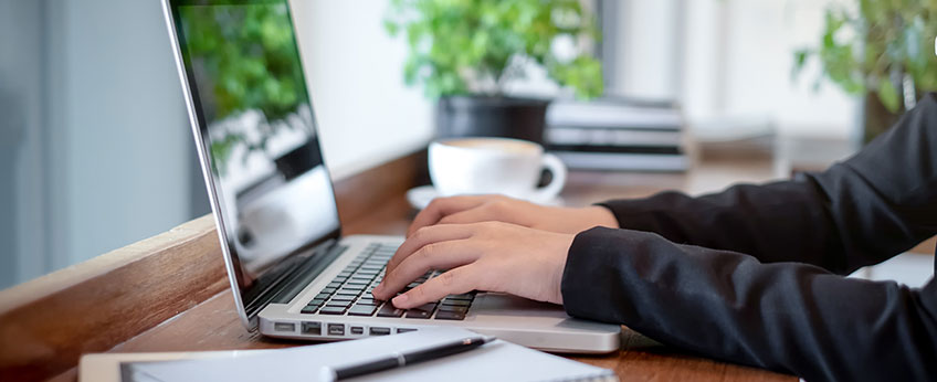 person typing on a laptop computer