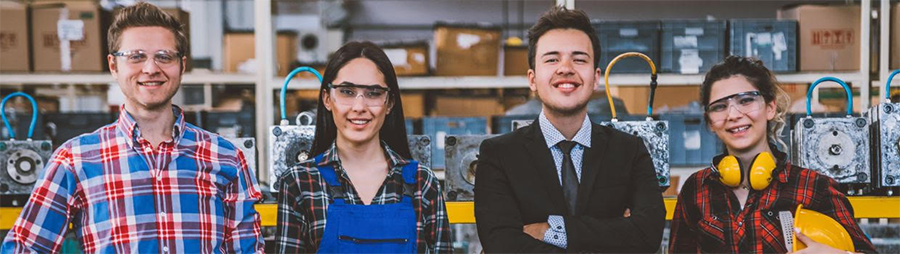Four people standing together in a workshop setting.
