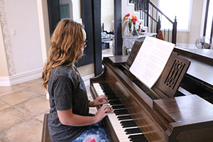 young woman playing a piano