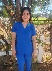 young woman wearing blue scrubs
