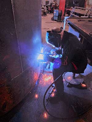 an ironworker using a welding machine